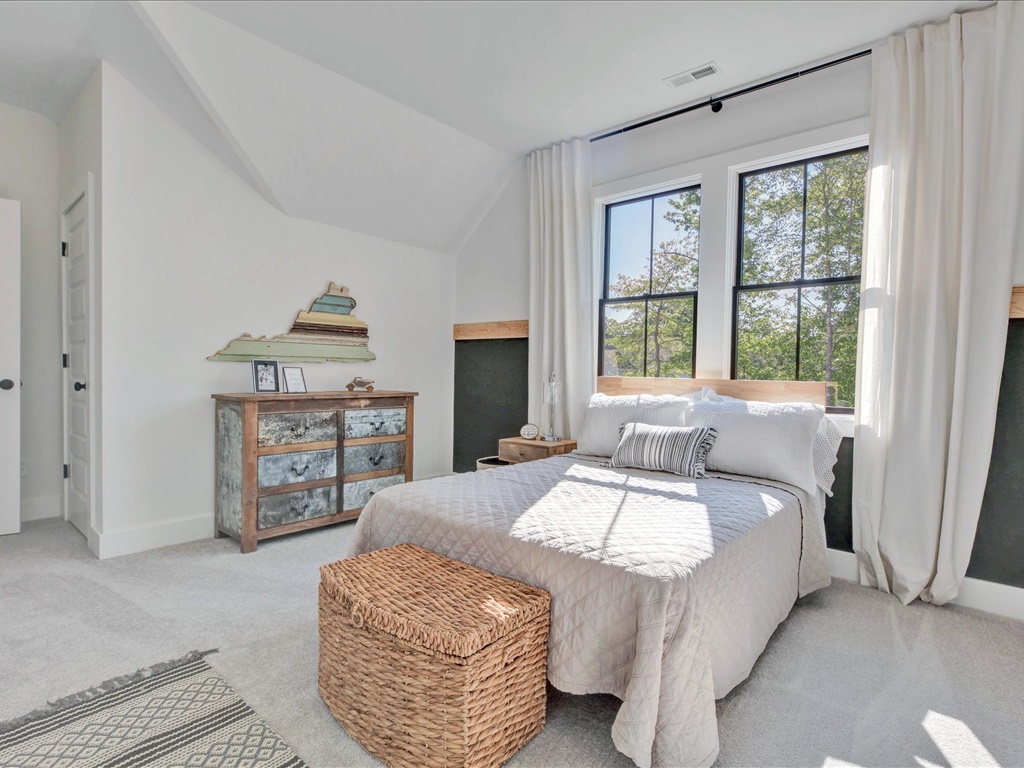 Sunlit bedroom with vaulted ceiling