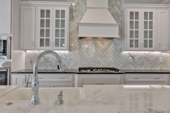 Chef's kitchen with custom cabinetry and quartz counters