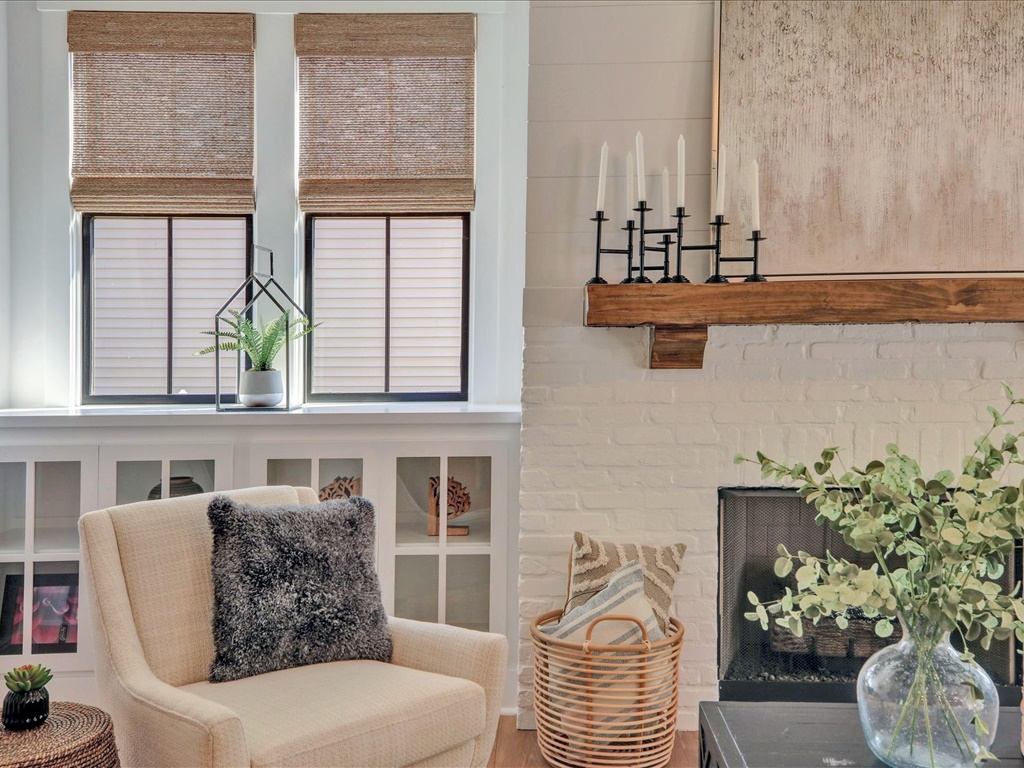 White brick fireplace with reclaimed wood mantel
