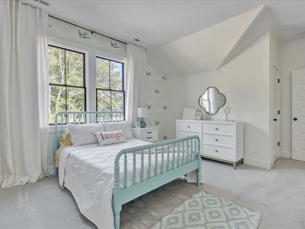 Bright guest bedroom with wallpaper accent