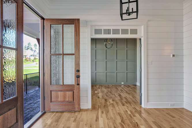 Two-story foyer with wide-plank hardwood