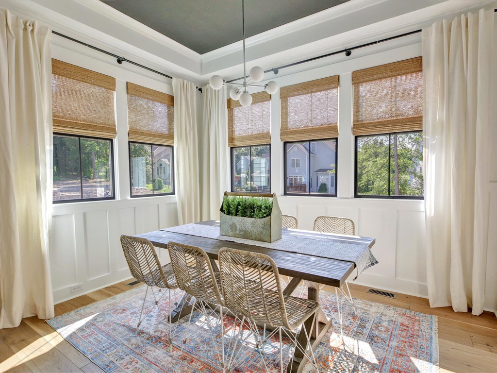 Breakfast area with tray ceiling and wall of windows