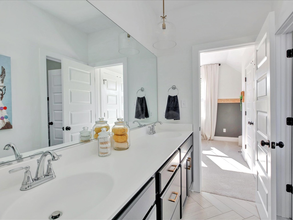 Double vanity with herringbone tile floor
